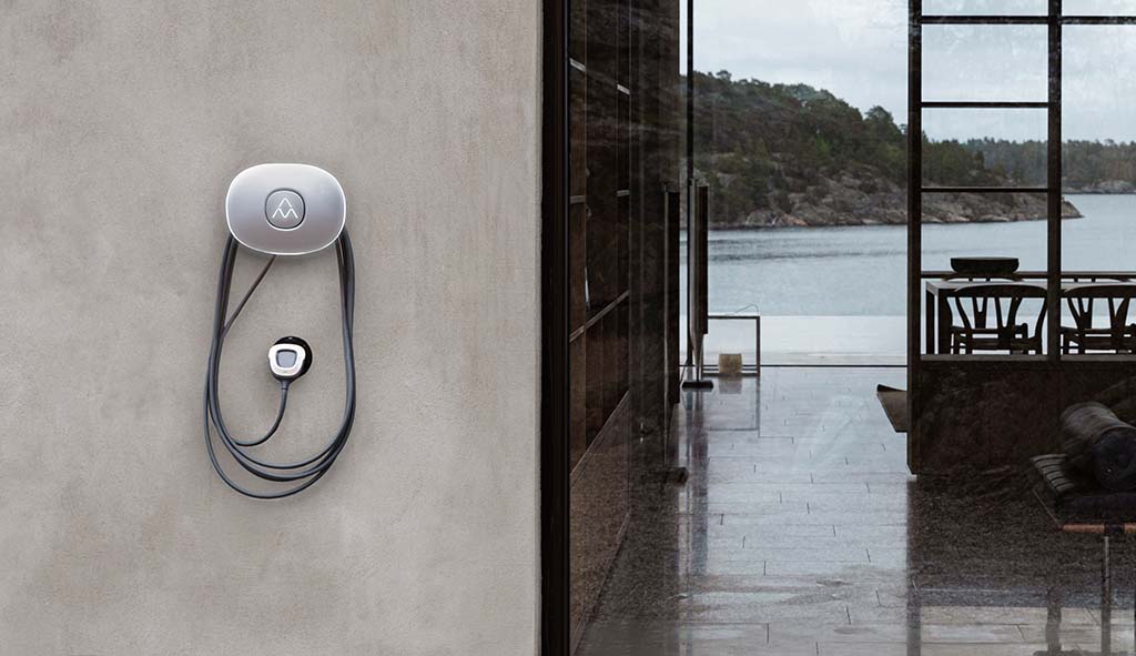 Charging station Charge Amps Halo on a concrete house facade
