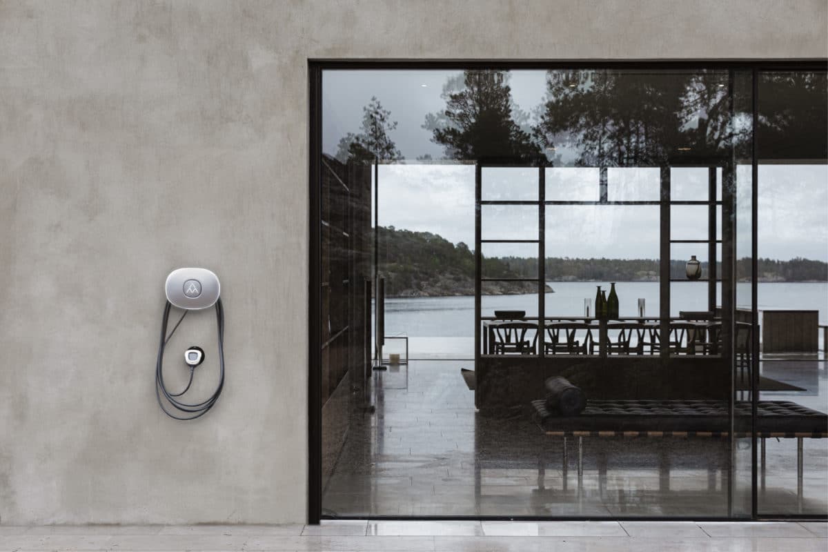 Charging station Charge Amps Halo on a concrete house facade