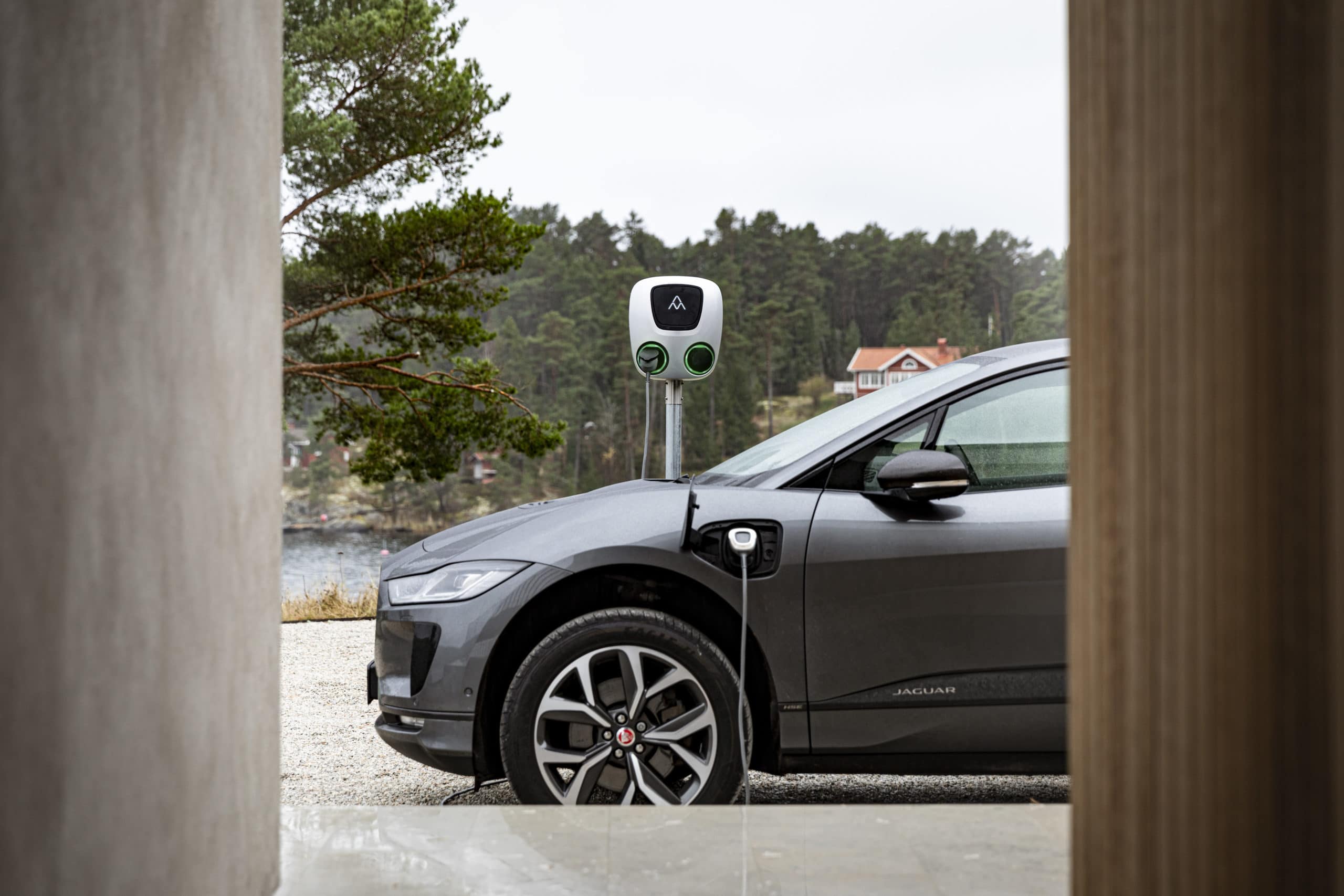 Charge Amps Aura Pole Mount, and a electric car